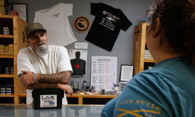 Photo of gun shop owner and customer