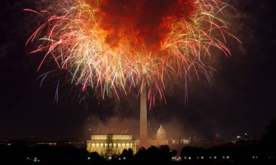 Photo of fireworks exploding over Lincoln Memorial, Washington Monument and U.S. Capitol