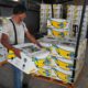 Photo of a worker stacking boxes of bananas