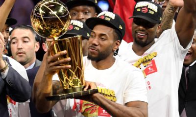 Photo of Kawhi Leonard holding the Larry O'Brien NBA Championship Trophy