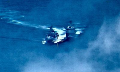 Photo of a Russian destroyer sailing close to the USS Chancellorsville in the Philippine Sea