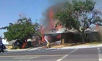 Photo of firefighter spraying a fire after California's Fourth of July earthquake