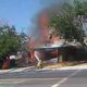 Photo of firefighter spraying a fire after California's Fourth of July earthquake
