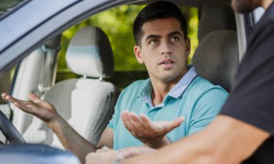 Photo of a man getting pulled over by a cop