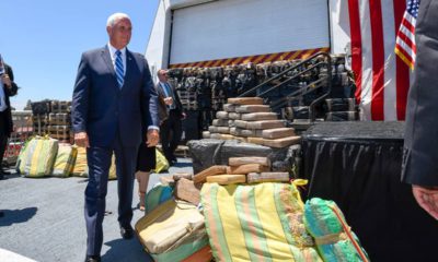 Photo of VP Mike Pence and bales of seized cocaine