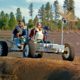 Photo of Apollo 15 astronauts, Jim Irwin and Dave Scott, driving a prototype of a lunar rover