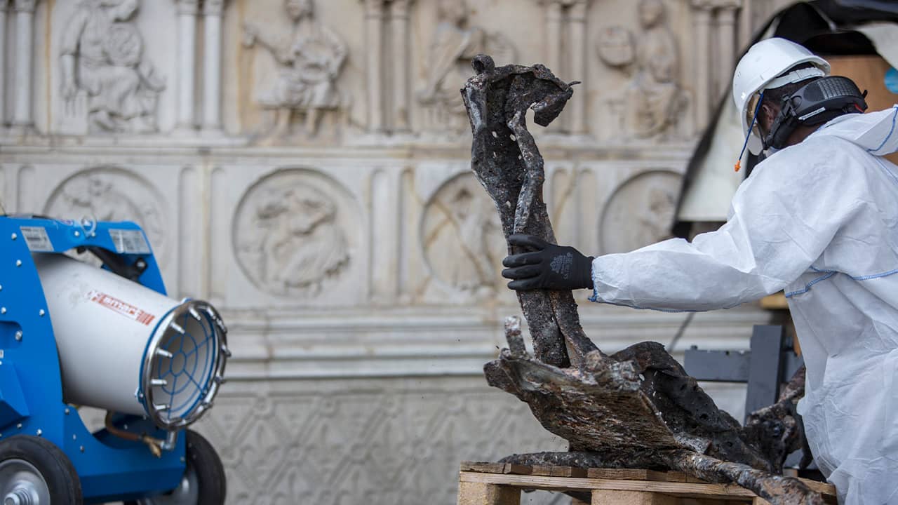Photo of worker cleaning debris at the Notre Dame Cathedral in Paris