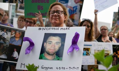 Photo of Christine Gagnon holding a sign during a protest