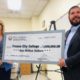 Photo of Carole Goldsmith and Assemblyman Joaquin Arambula holding a check