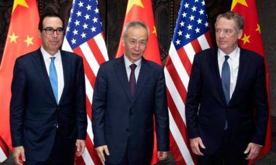 Photo of Chinese Vice Premier Liu He, center, posing with U.S. Trade Representative Robert Lighthizer, right, and Treasury Secretary Steven Mnuchin