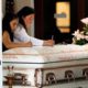 Photo of mourners writing on Keyla Salazar's casket during her funeral