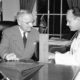 Photo of Brigadier Gen. Wallace Harry Graham, right, personal physician of President Harry S. Truman checking his blood pressure