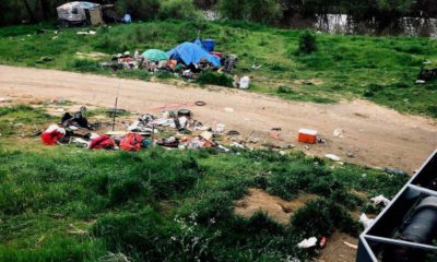Photo of trash and a homeless tent in Sacramento