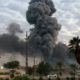 Photo of plumes of smoke rising at a military base in Baghdad, Iraq