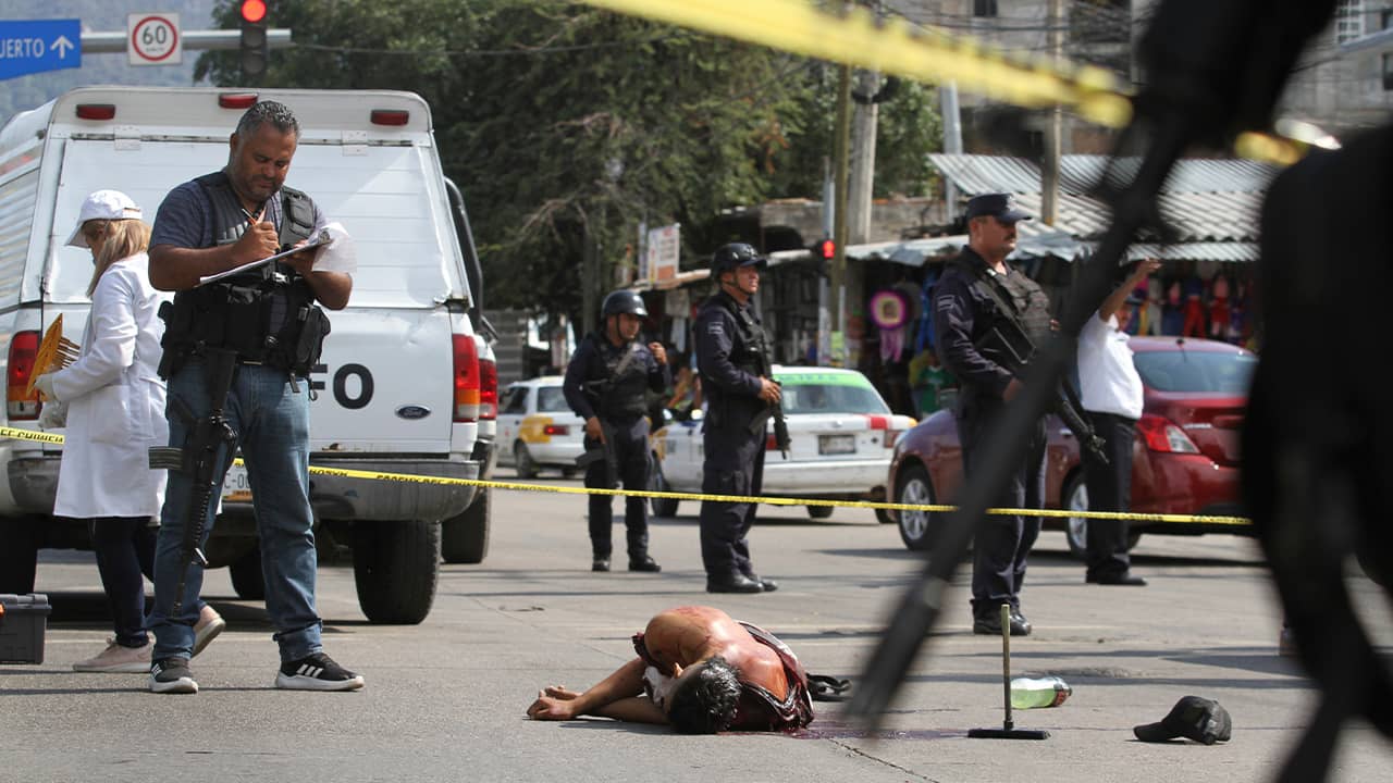Photo of a bloodied man laying in the street in Mexico