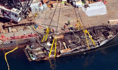 Photo of the Conception being brought out of the water by a salvage team