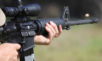 Photo of a man firing a machine gun