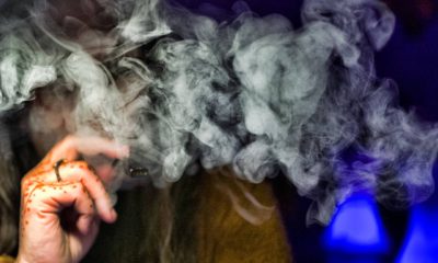 Photo of a person hidden behind vape smoke