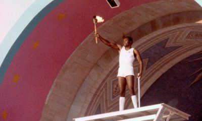 Photo of Rafer Johnson holding the Olympic torch in 1984