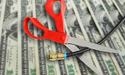 Composite image of money, scissors and cable TV cord