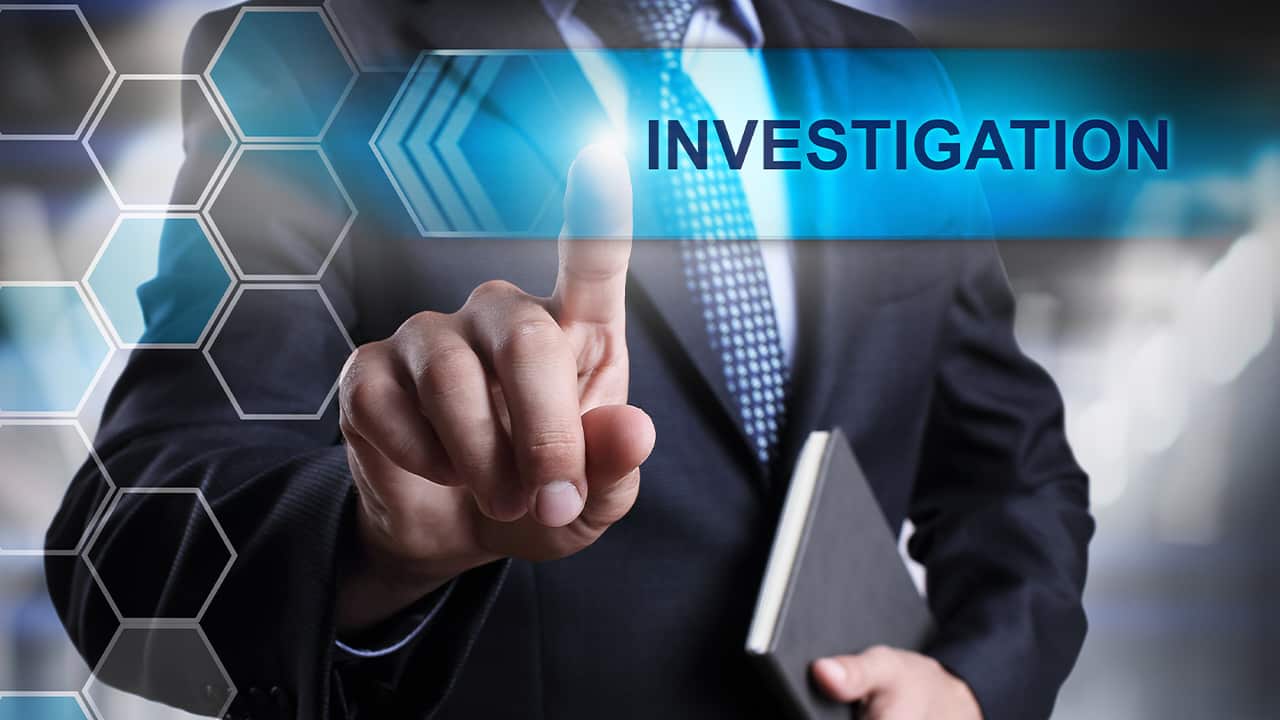 Photo of a businessman with the word "investigation" signifying potential fraud