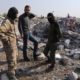 Photo of people looking at destroyed houses