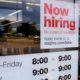 Photo of "Now Hiring" sign on the front door of a Staples store