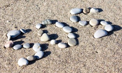 Photo of SOS spelled in rocks