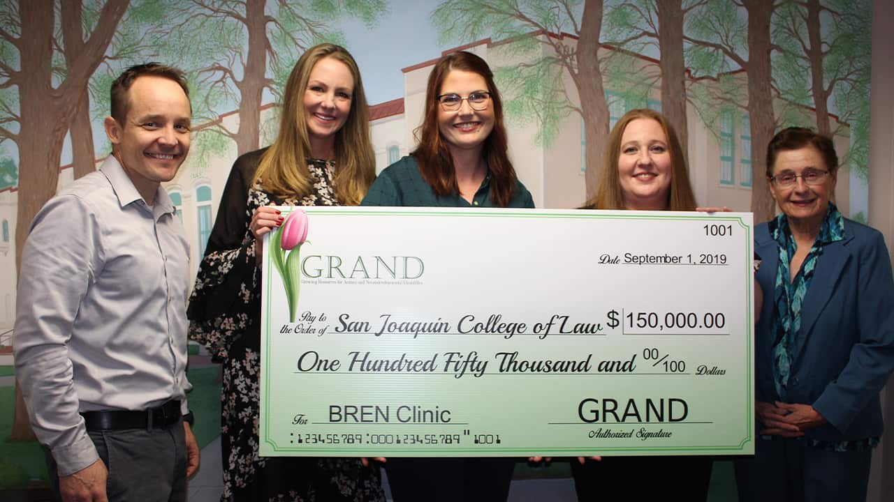 Photo of check presentation of $150,000 from GRAND to the SJCL for the BREN Clinic