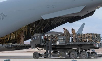 Photo of U.S. service members loading military equipment