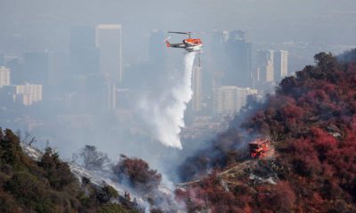 Photo of a helicopter dropping water on the Getty Fire