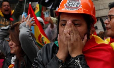 Photo of opponents of Bolivia's Present Evo Morales celebrating after he announced his resignation