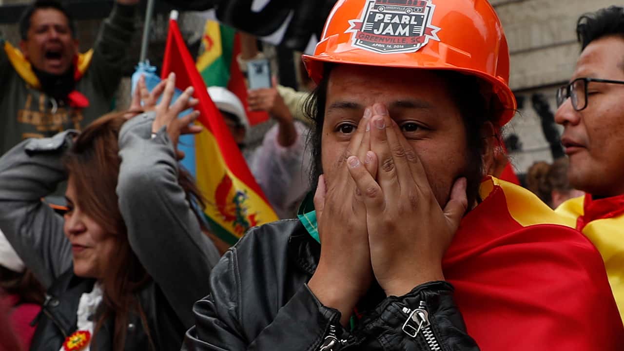 Photo of opponents of Bolivia's Present Evo Morales celebrating after he announced his resignation