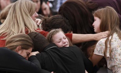 Photo of family and friends weeping at a funeral