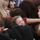 Photo of family and friends weeping at a funeral