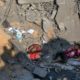 Photo of Palestinians sitting amid rubble