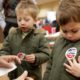 Photo of kids putting on an "I Voted" sticker