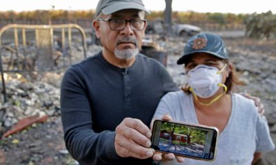 Photo of Justo and Bernadette Laos showing a photo of their home before it burned down