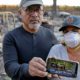 Photo of Justo and Bernadette Laos showing a photo of their home before it burned down