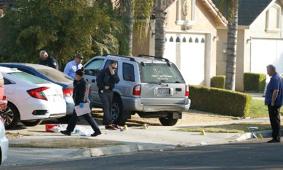 Photo of Fresno police investigators working in the driveway