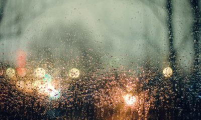 photo of rain and lights seen through a window