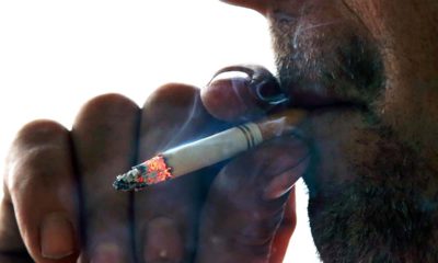 Photo of a man smoking a cigarette