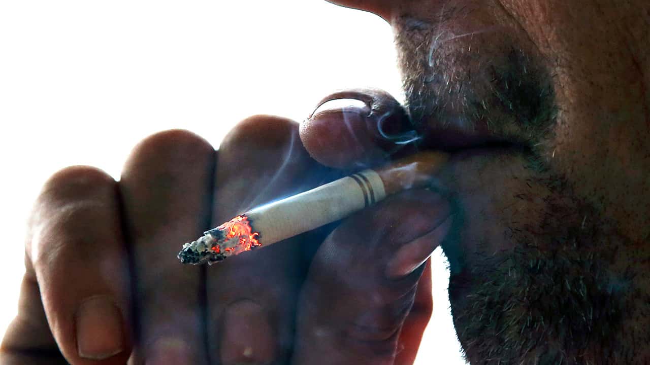 Photo of a man smoking a cigarette