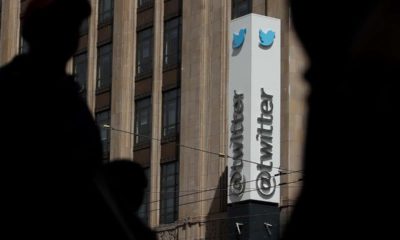 Photo of pedestrians walking across from the Twitter office building