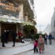 Photo of people walking by "The Walled Off Hotel"