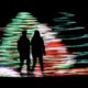 Photo of people against a Christmas lights display