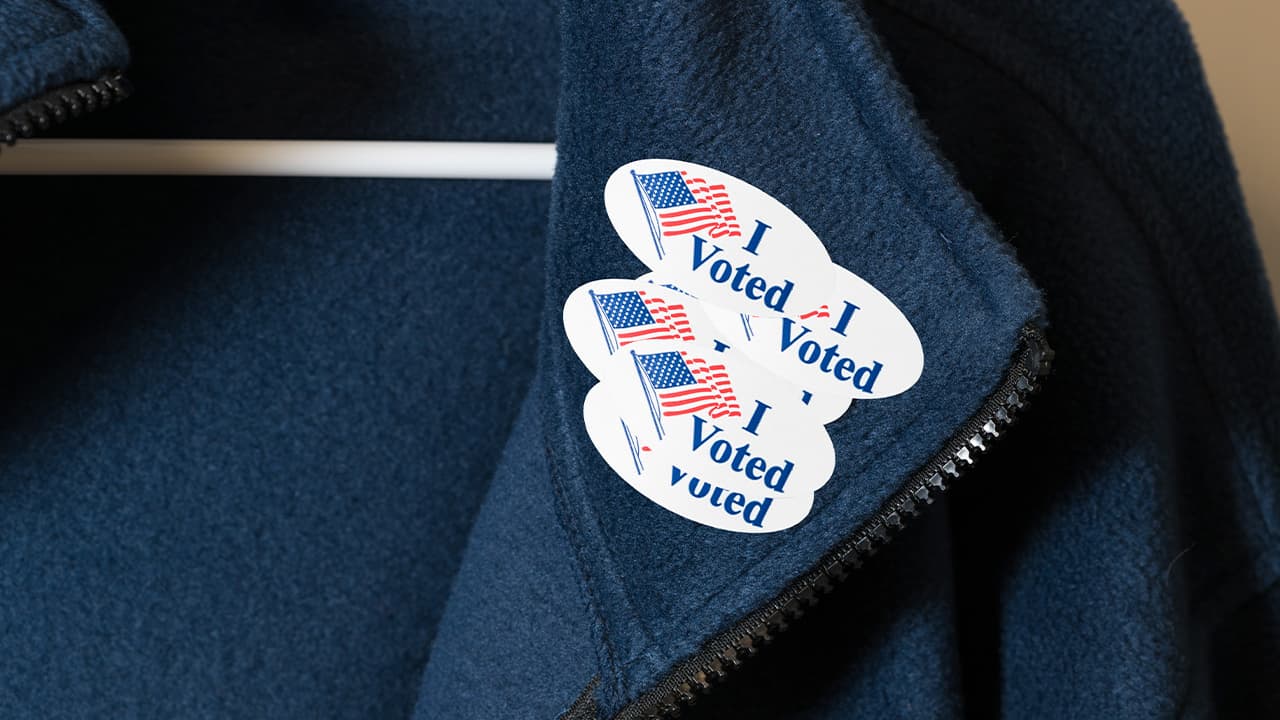 Photo of a jacket with multiple "I Voted" stickers