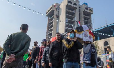 Photo of mourners carry the body of their fellow protestor