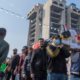 Photo of mourners carry the body of their fellow protestor
