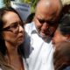 Photo of Julian LeBaron embracing two women before a protest